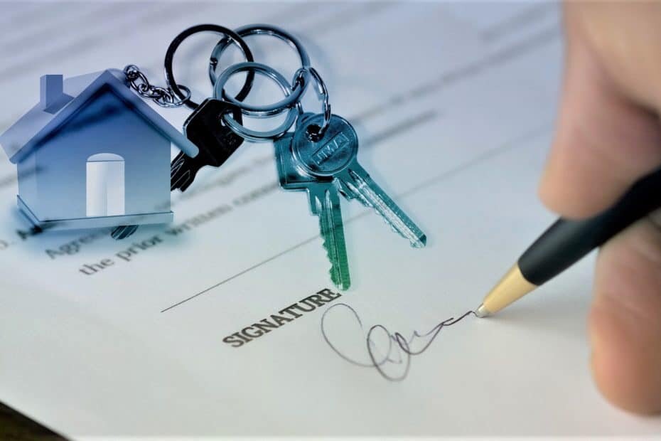 Someone signing a contract with a set of house keys on top of the paper, the keychain in a miniature house