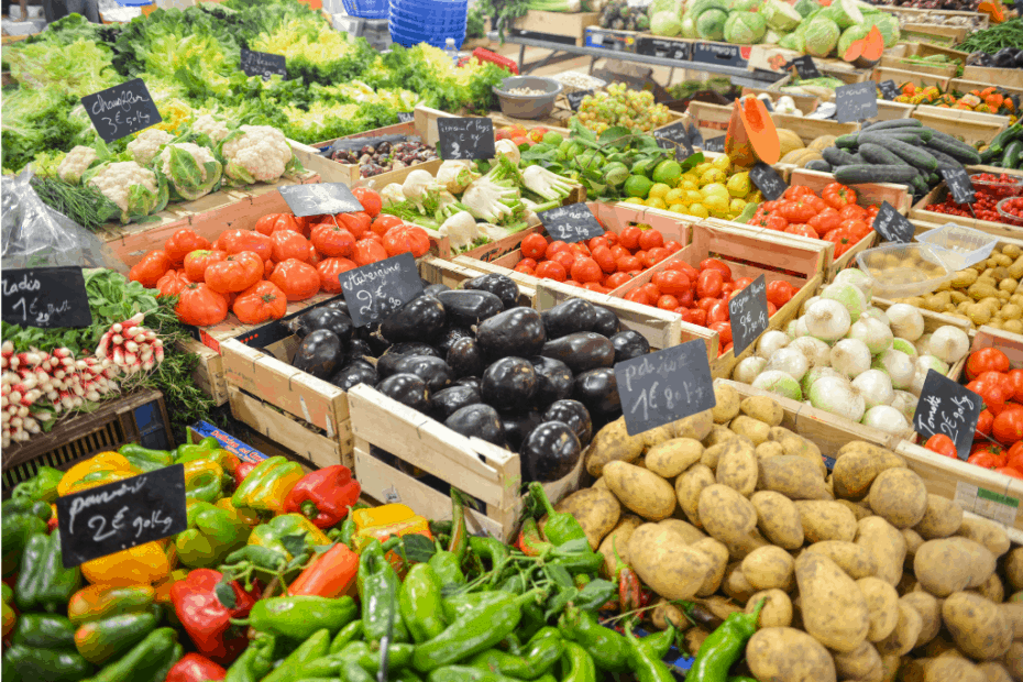 Plentiful vegetables and fruits in wooden crates at a market