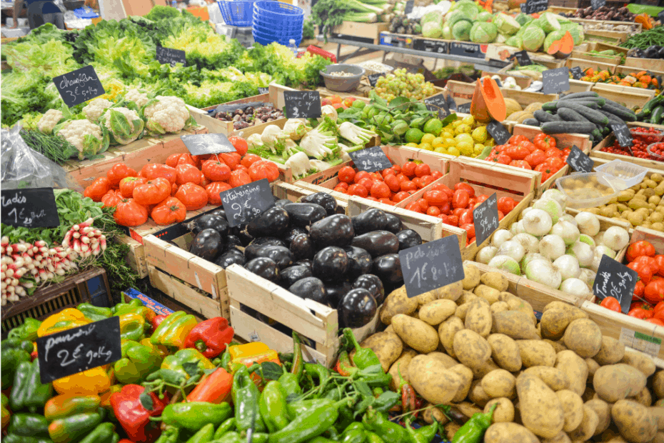 Plentiful vegetables and fruits in wooden crates at a market