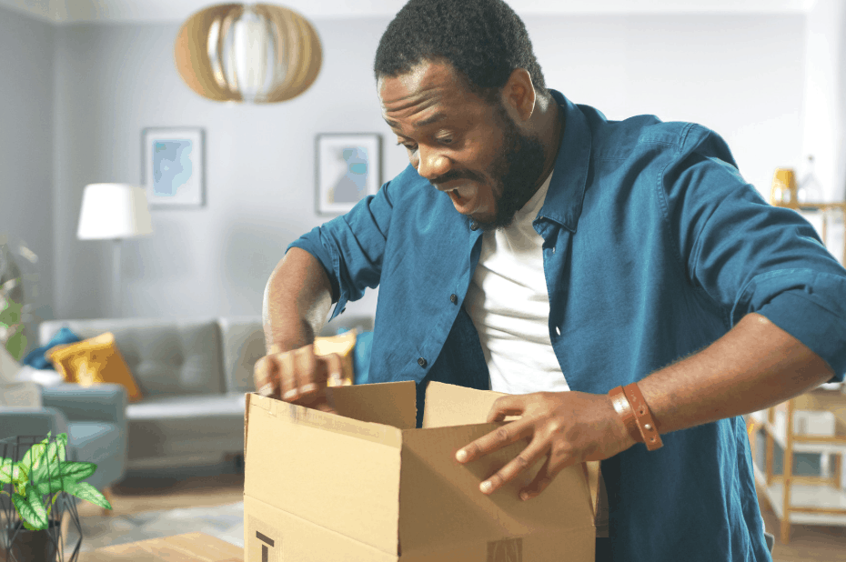 Man opening cardboard box from Amazon Prime Day